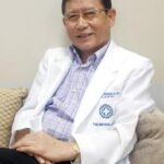 Dr. Cornelio Banaag Jr. seated in a white medical coat