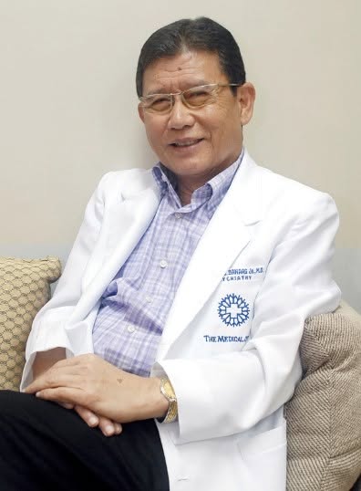 Dr. Cornelio Banaag Jr. seated in a white medical coat